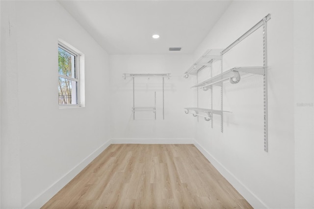 walk in closet with light wood-type flooring and visible vents