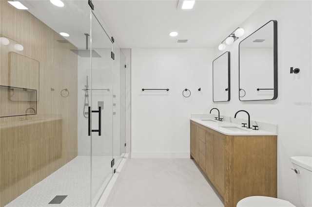 bathroom featuring visible vents, a stall shower, a sink, and toilet