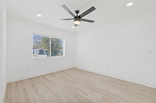 unfurnished room with light wood-style floors, baseboards, and recessed lighting