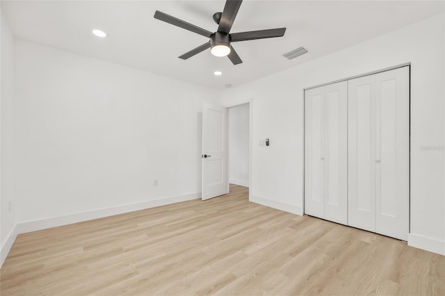 unfurnished bedroom featuring light wood finished floors, recessed lighting, a closet, visible vents, and baseboards