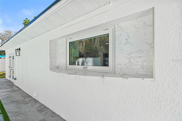 view of side of property with french doors and stucco siding