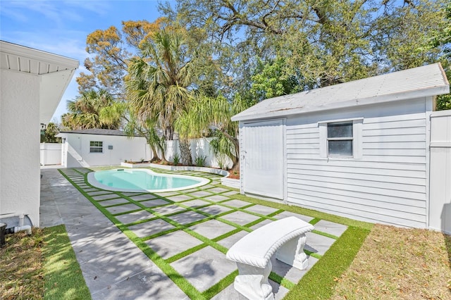 view of swimming pool with a patio area, a fenced backyard, a fenced in pool, and an outdoor structure