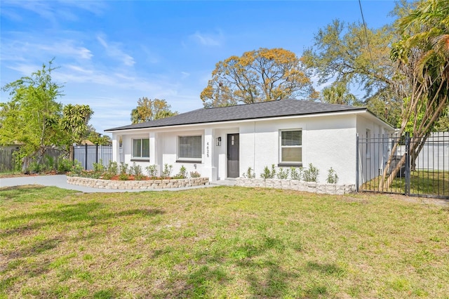 single story home featuring a front yard, fence, and stucco siding