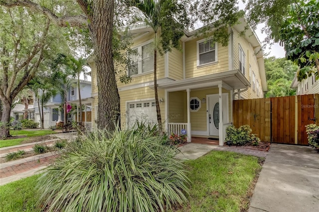 view of front of home with a garage and fence