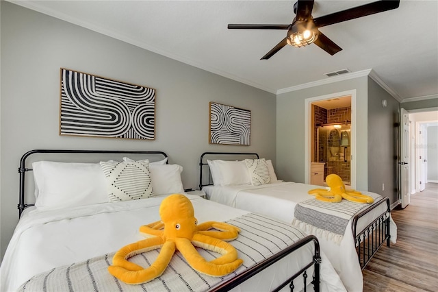 bedroom with ensuite bathroom, visible vents, baseboards, light wood-style floors, and ornamental molding