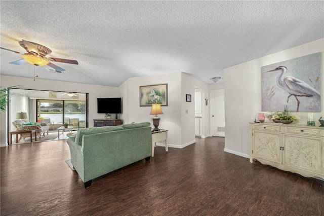 living area featuring a textured ceiling, visible vents, and dark wood-type flooring