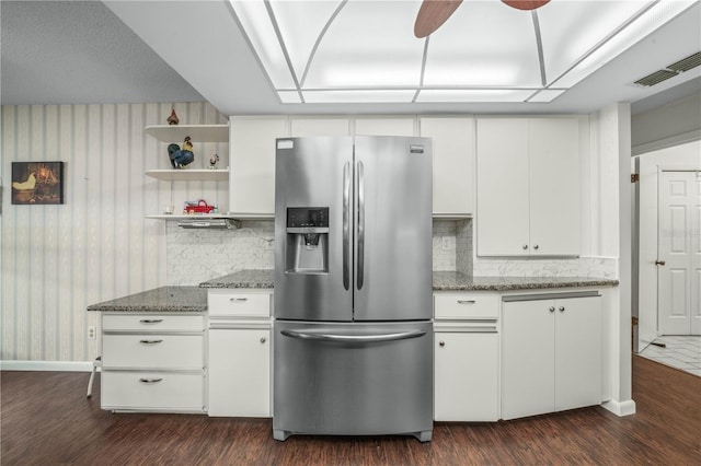 kitchen with stainless steel fridge, visible vents, dark wood-type flooring, white cabinetry, and open shelves