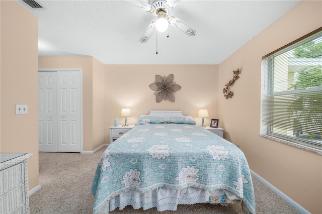 bedroom featuring carpet floors, a closet, visible vents, ceiling fan, and baseboards