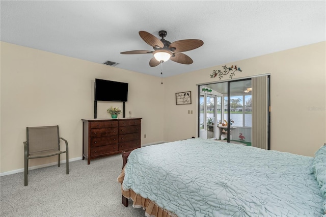 carpeted bedroom with access to exterior, visible vents, ceiling fan, and baseboards