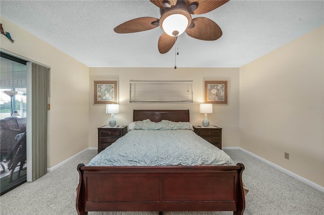 carpeted bedroom featuring a textured ceiling, a ceiling fan, and baseboards