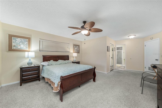 bedroom featuring carpet floors, baseboards, and a textured ceiling