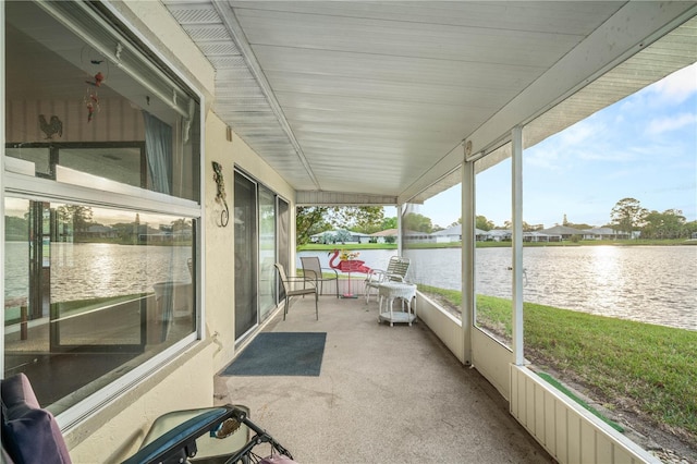 unfurnished sunroom with a water view