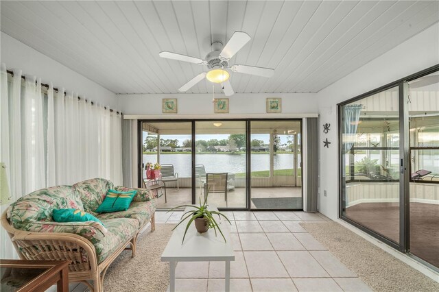 sunroom featuring wooden ceiling, a water view, and ceiling fan