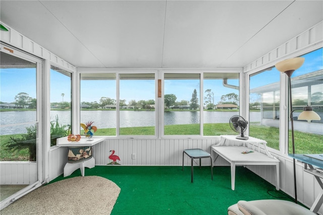 sunroom / solarium featuring a water view