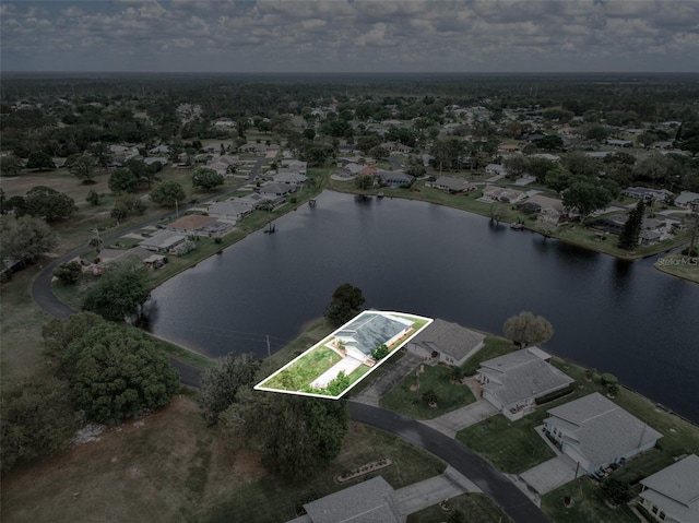 birds eye view of property with a water view and a residential view