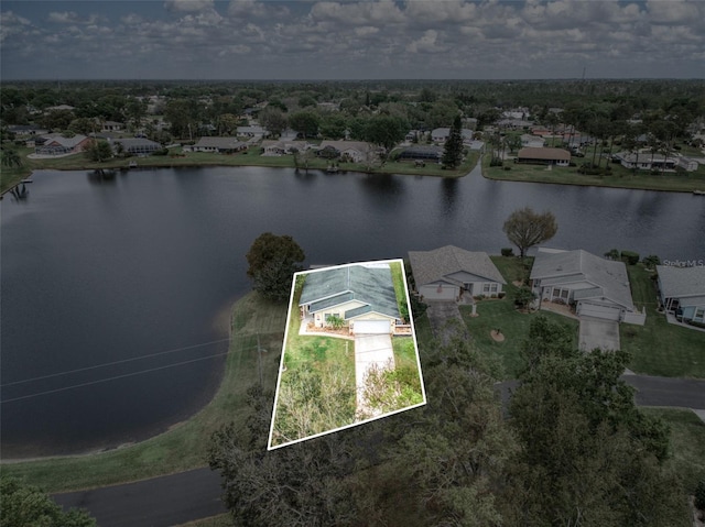 drone / aerial view featuring a water view and a residential view