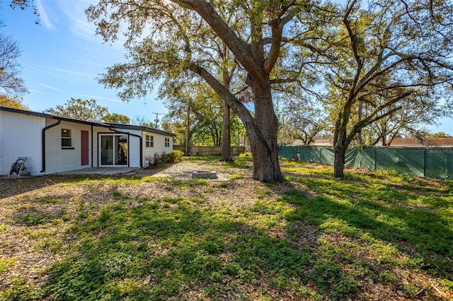 view of yard with a patio area and a fenced backyard