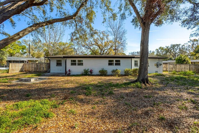 back of property featuring fence