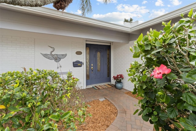 property entrance featuring brick siding