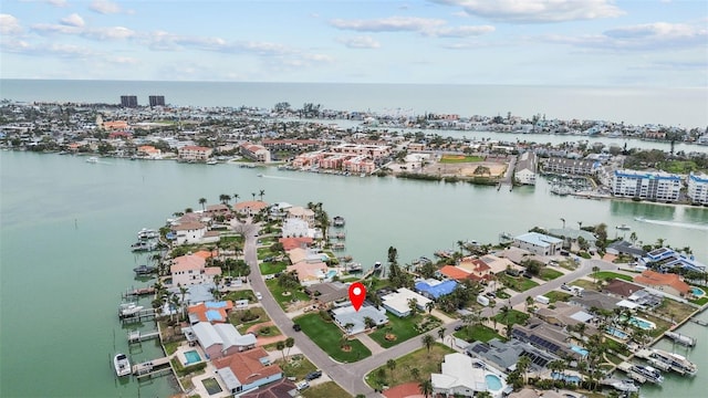 birds eye view of property with a water view and a view of city