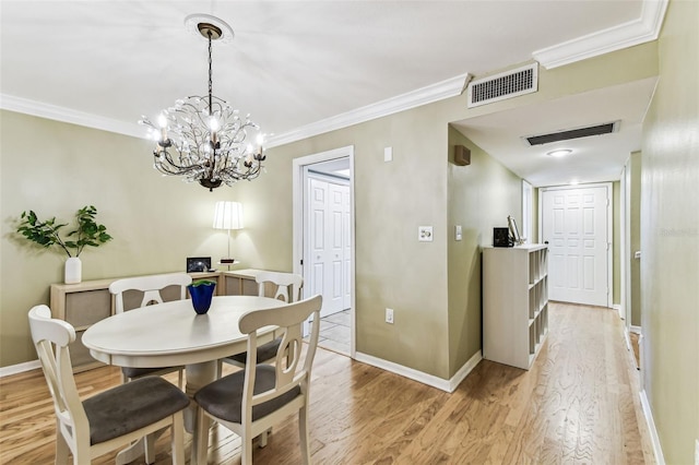 dining space with light wood-type flooring, visible vents, crown molding, and baseboards