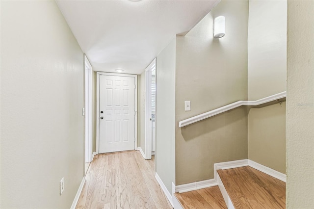 hallway with baseboards and wood finished floors