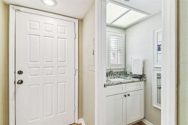 bathroom featuring baseboards and vanity