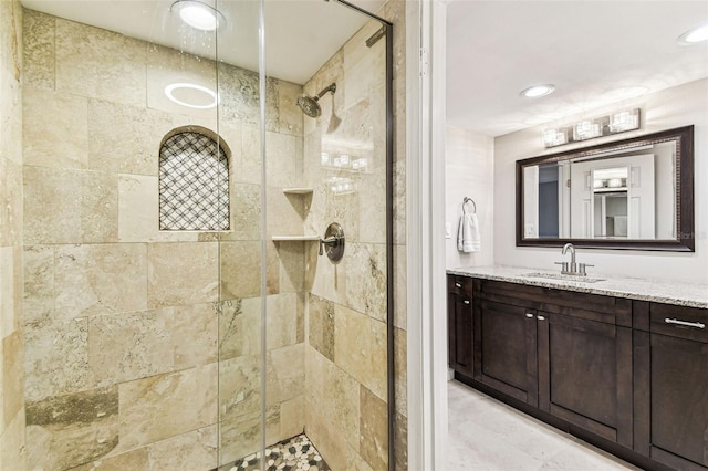 bathroom with a shower stall, vanity, and recessed lighting