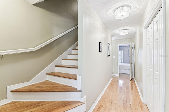 staircase featuring wood-type flooring and baseboards