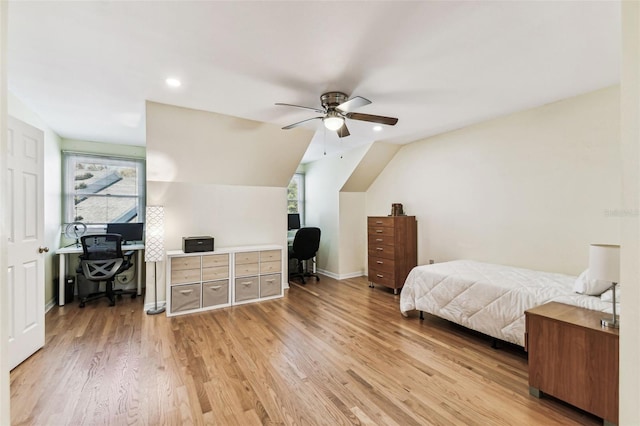 bedroom with vaulted ceiling, ceiling fan, light wood finished floors, and baseboards