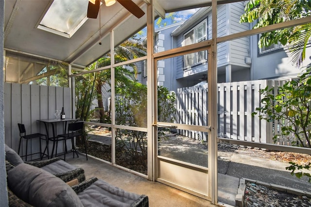 sunroom with a ceiling fan and lofted ceiling