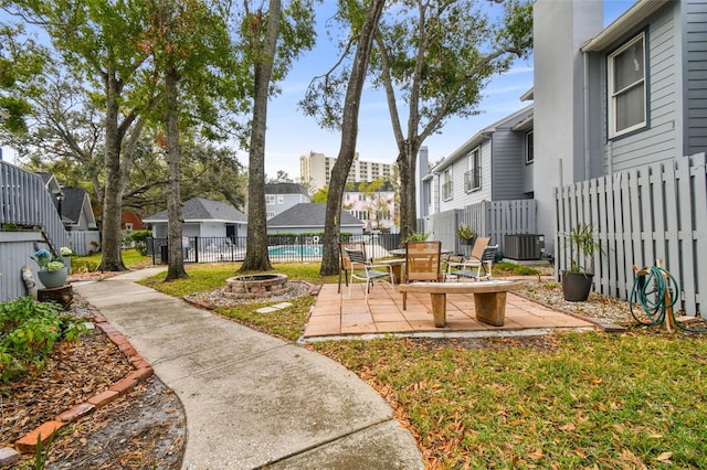 surrounding community with an outdoor fire pit, a patio area, a fenced backyard, and a residential view
