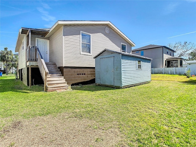 view of home's exterior featuring a lawn, fence, and a shed