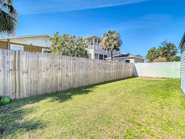 view of yard with a fenced backyard