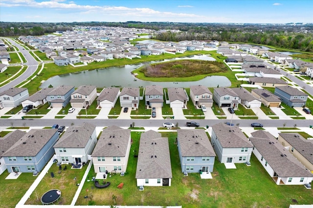 birds eye view of property featuring a water view and a residential view