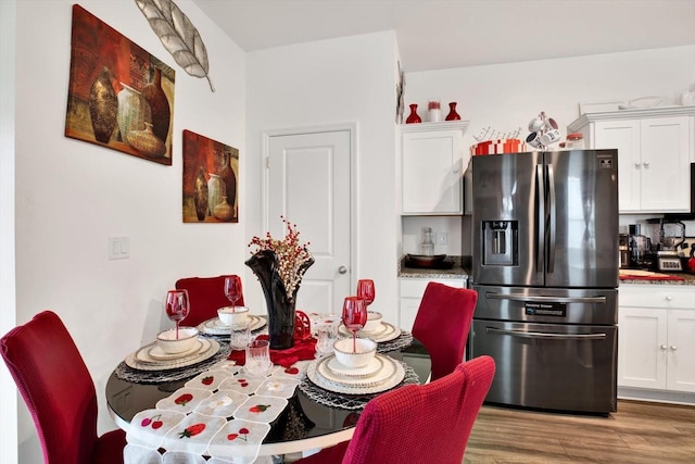 dining space featuring wood finished floors