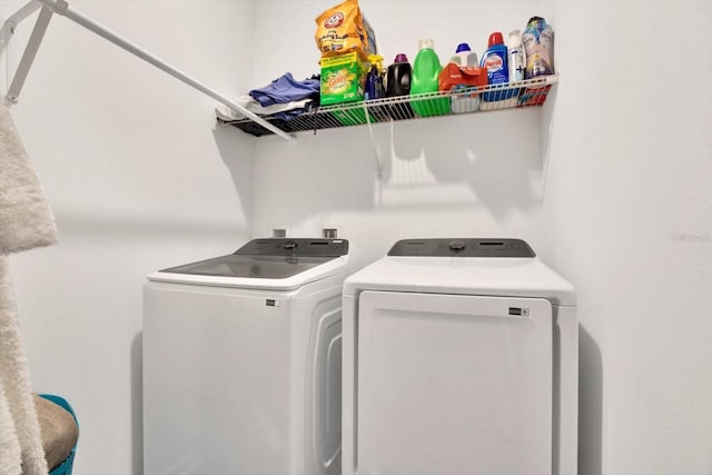 laundry room with laundry area and washing machine and clothes dryer