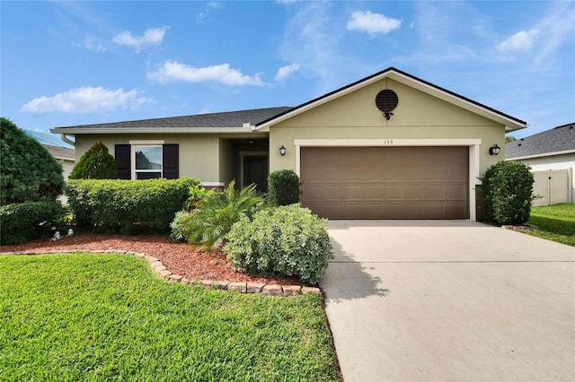 ranch-style home with an attached garage, a front lawn, concrete driveway, and stucco siding