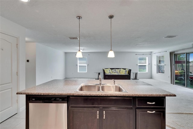 kitchen with visible vents, stainless steel dishwasher, open floor plan, a sink, and dark brown cabinets