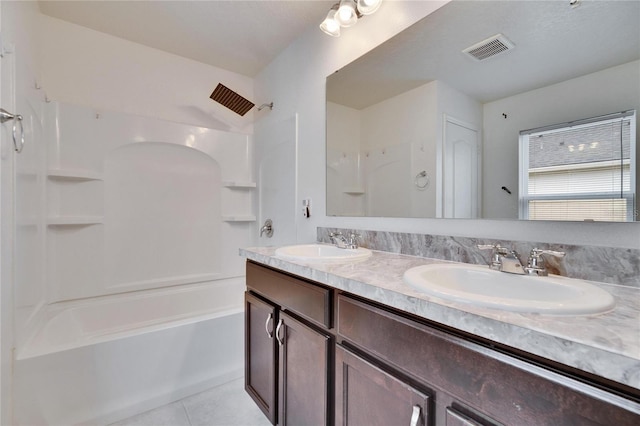 bathroom with tile patterned flooring, visible vents, a sink, and shower / bathing tub combination