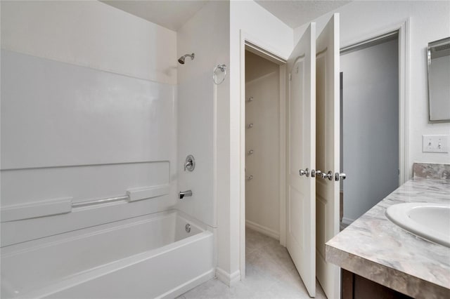 bathroom with shower / bath combination, vanity, baseboards, and tile patterned floors