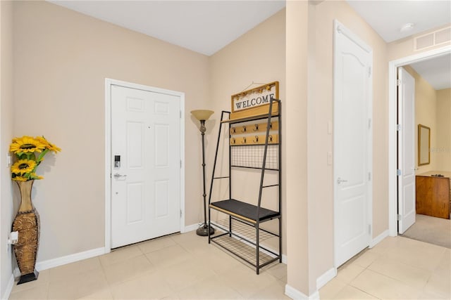 foyer with visible vents, baseboards, and light tile patterned flooring