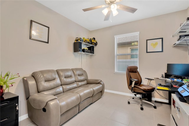 office space with a ceiling fan, baseboards, and light tile patterned floors