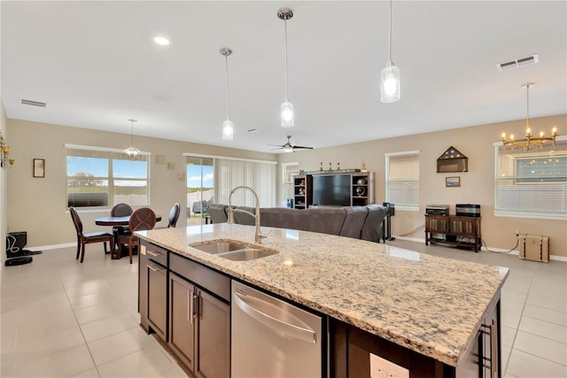 kitchen featuring a sink, visible vents, open floor plan, stainless steel dishwasher, and an island with sink