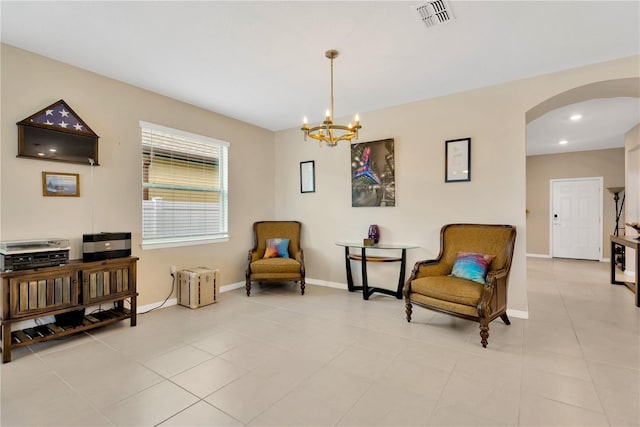 living area featuring arched walkways, recessed lighting, visible vents, radiator heating unit, and baseboards