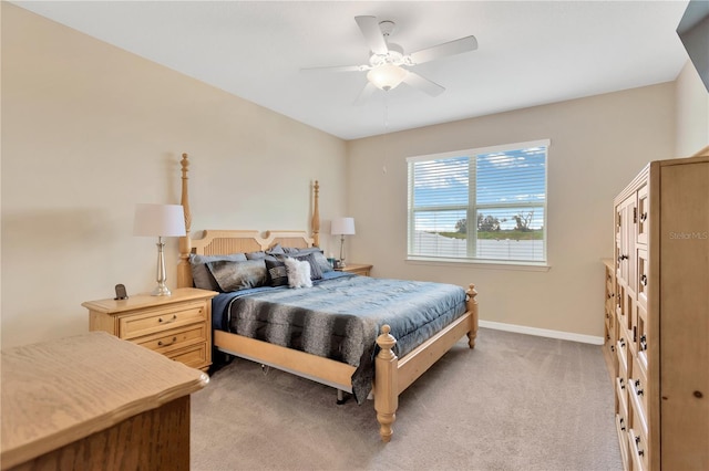 bedroom with baseboards, a ceiling fan, and light colored carpet