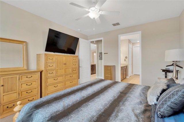 bedroom with ceiling fan, ensuite bath, and visible vents