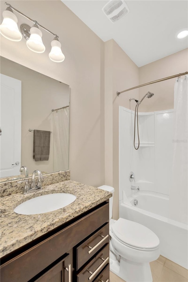 bathroom featuring toilet, vanity, visible vents, tile patterned floors, and shower / bath combo with shower curtain