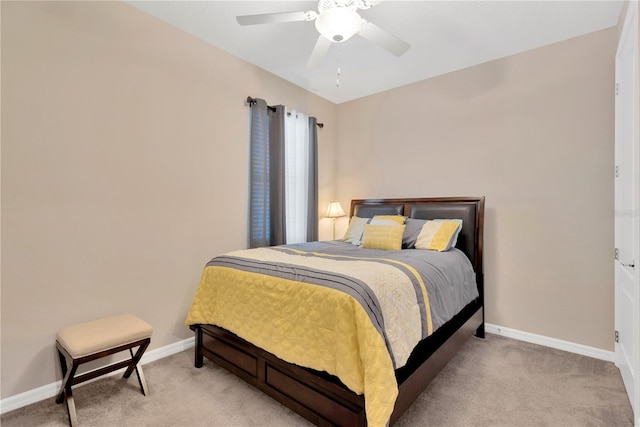 bedroom featuring light carpet, ceiling fan, and baseboards