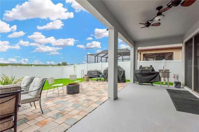 view of patio / terrace featuring grilling area, a fenced backyard, and a ceiling fan